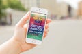 RIGA, LATVIA - July 14, 2016: Person holding mobile phone and showing Pokemon Go website. Pokemon Go is a location-based augmented