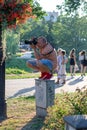 RIGA, LATVIA - JULY 26, 2018: The photographer ascended up to the electric cabinet in a city park Royalty Free Stock Photo