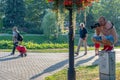 RIGA, LATVIA - JULY 26, 2018: The photographer ascended up to the electric cabinet in a city park Royalty Free Stock Photo