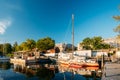 Riga, Latvia. Old Yacht Moored At The City Pier Harbour Bay And Quay In Summer Sunny Evening. Reflections From Boats In Royalty Free Stock Photo