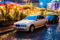 Riga, Latvia. Sedan Car BMW 5 Series E39 Parking Near Street Cafe In Evening Or Night Illumination In Old Town On Kalku Royalty Free Stock Photo