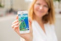 RIGA, LATVIA - July 14, 2016: Woman showing sample screenshot of Pokemon Go on the phone. Pokemon Go is a location-based augmented