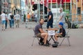 RIGA, LATVIA - JULY 26, 2018: A young boy on the street playing chess for money