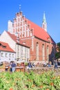 RIGA, LATVIA - JUNE 12, 2017: Old city streets. The Church of St. John is a Lutheran church in Riga