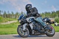 12-05-2020 Riga, Latvia. man on a motorbike on the road riding. having fun driving the empty road on a motorcycle tour journey Royalty Free Stock Photo