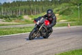 12-05-2020 Riga, Latvia. man on a motorbike on the road riding. having fun driving the empty road on a motorcycle tour journey Royalty Free Stock Photo