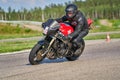 12-05-2020 Riga, Latvia. man on a motorbike on the road riding. having fun driving the empty road on a motorcycle tour journey Royalty Free Stock Photo