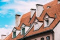 Riga Latvia. Mansard Tile Roof With Four Gable Fronted Dormer Windows On The Old Building Under Blue Sky Royalty Free Stock Photo