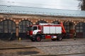 RIGA, LATVIA - MARCH 16, 2019: Fire truck is being cleaned - Driver washes firefighter truck at a depo - Old man passing