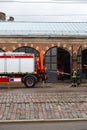 RIGA, LATVIA - MARCH 16, 2019: Fire truck is being cleaned - Driver washes firefighter truck at a depo - Van in a garage