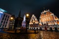 RIGA, LATVIA - MARCH 17, 2019: Professional long exposure shot at a rainy night facing House of Blackheads, statue of