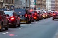 RIGA, LATVIA - MARCH 27, 2019: Traffic jams in the city with row of cars on the road at evening and bokeh lights - image