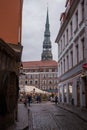 RIGA, LATVIA: Maza Miesnieku iela street. Narrow medieval cobbled street with tenement houses in the old town of Riga. Retro Royalty Free Stock Photo