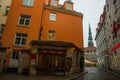 RIGA, LATVIA: Maza Miesnieku iela street. Narrow medieval cobbled street with tenement houses in the old town of Riga. Retro Royalty Free Stock Photo