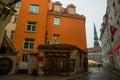 RIGA, LATVIA: Maza Miesnieku iela street. Narrow medieval cobbled street with tenement houses in the old town of Riga. Retro Royalty Free Stock Photo