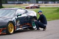 21-10-2021 Riga, Latvia Mechanic changing the wheels of a high-end super sports car. Auto mechanic working in garage. Repair Royalty Free Stock Photo