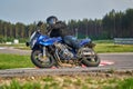 11-05-2020 Riga, Latvia. Motor biker on a race circuit speeding round a corner with a race circuit kerb behind