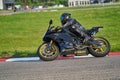 11-05-2020 Riga, Latvia. Motor biker on a race circuit speeding round a corner with a race circuit kerb behind