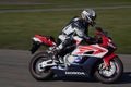 11-05-2021 Riga, Latvia Motorcyclist at sport bike rides by empty asphalt road. blue white red street motorcycle. MotoGP race.