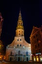 Riga, Latvia: Night View Of St. Peter`s Church In Old Town Riga Latvia. Illuminated Street Royalty Free Stock Photo