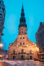 Riga, Latvia. Night View Of St. Peter`s Church In Old Town Riga Latvia. Illuminated Street Royalty Free Stock Photo