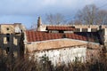 Abandoned factory outdoors at sunny autumn day with brown brick walls and chimney against blue sky background