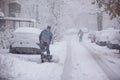 RIGA, LATVIA - NOVEMBER 4: Man cleaning snow from a walkway, snow storm