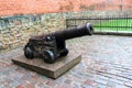 Riga, Latvia, November 2019. An old cannon near the fortress wall in the historical part of the city.