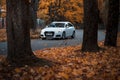 Riga, Latvia-October 6, 2021: Blurred image of White Audi A4 avant driving on the city street during the beautiful autumn