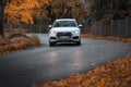 Riga, Latvia-October 6, 2021: White Audi Q5 driving on the city street during the beautiful autumn