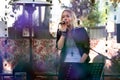 RIGA, LATVIA - SEPTEMBER 14, 2018: A blonde woman sings a karaoke outdoor cafe.