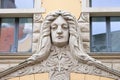 Riga, Latvia, September, 17, 2019: Building with face on facade in art nouveau style in the center of old town of Riga. Stone scul Royalty Free Stock Photo