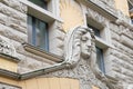 Riga, Latvia, September, 17, 2019: Building with face on facade in art nouveau style in the center of old town of Riga. Stone scul Royalty Free Stock Photo