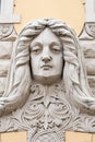 Riga, Latvia, September, 17, 2019: Building with face on facade in art nouveau style in the center of old town of Riga. Stone scul Royalty Free Stock Photo