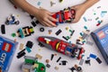 Riga, Latvia - September 12, 2023: child playing with Lego constructor on the table. building a firefighter car Royalty Free Stock Photo