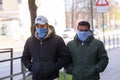 Men wearing face protective mask walks in the city.