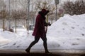 A person walks on the street, during snowfall