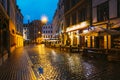 Riga, Latvia. Traditional Cafe In Lighting At Evening Or Night Illumination In Old Town In Tirgonu Street Royalty Free Stock Photo