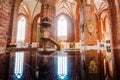 Riga Latvia. Wooden Pulpit In Interior Of St. Peter Church, Reflected On Black Glossy Piano Surface