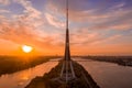 Riga Radio and TV Tower surrounded by water during the sunset in Latvia
