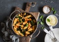 Rigatoni pasta with chickpeas, spinach and olives in a tomato sauce on a dark background, top view. Royalty Free Stock Photo