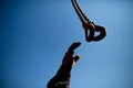 Rigger construction worker hand wearing a heavy duty glove reaching to the sky to catching crane chain block hooks Royalty Free Stock Photo