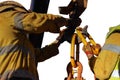 Rigger hands wearing a heavy duty safety protection glove while performing opening crane hook clip on open field with while backgr