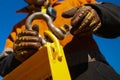 Rigger high risk worker wearing safety heavy duty glove, fastening tensioning pin into D- shape shackle Royalty Free Stock Photo