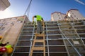 Rigger, worker climbed on wooden ladder to assembly demountable mold Royalty Free Stock Photo