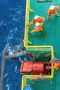 Riggers working on anchor handling on a construction wok barge at offshore Terengganu oil field during sunrise