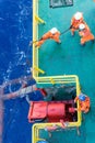 Riggers working on anchor handling on a construction wok barge at offshore Terengganu oil field during sunrise