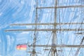 Rigging and masts of a big sailing ship in front of a blue sky w Royalty Free Stock Photo