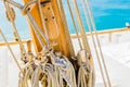 Classical sailing boat wooden mast with tied nautical ropes Royalty Free Stock Photo