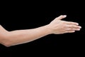 Right back hand of a woman trying to reach or grab something. fling, touch sign. Reaching out to the left. isolated on black Royalty Free Stock Photo